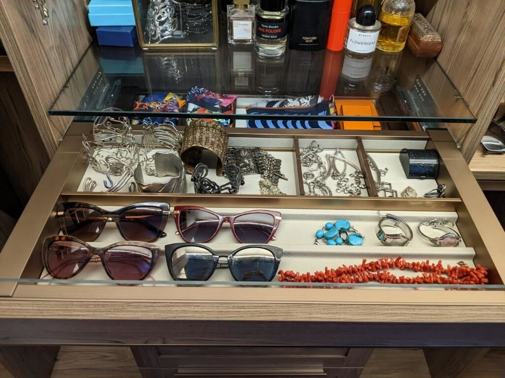 Tan closet shelving with organized accessories Custom reach in closet