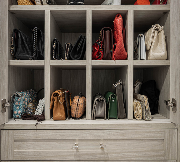 Custom Organization Solutions close up photo of gray closet with dedicated grid storage for purses and crystal hardware for handles on drawers Tribeca New York