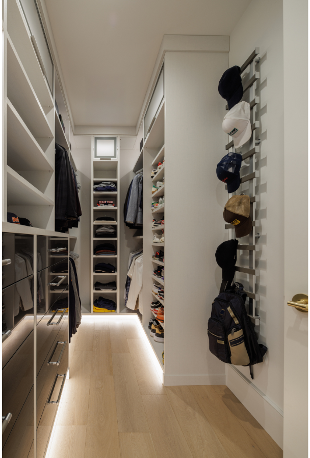 Luxury Men's Walk-in Closet California Closets New City Rockland County NY Custom Men's Walk in Closet High Gloss Black Drawer Fronts Custom Maddox Hanging System for Accessories Hanging Shelving and Custom Drawer Space LED Lighting