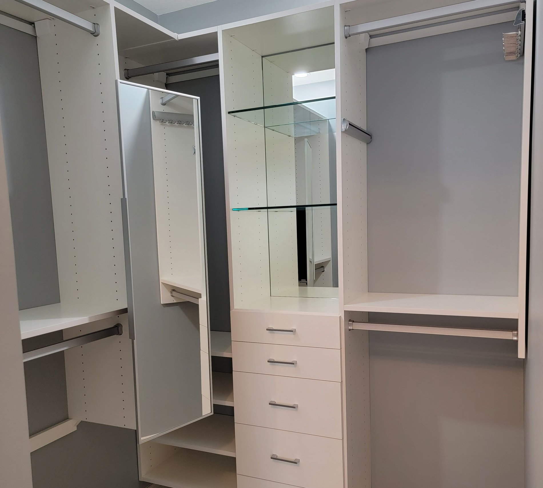 White Walk-In Closet with Mirrors White walk-in closet with a pull-out mirror