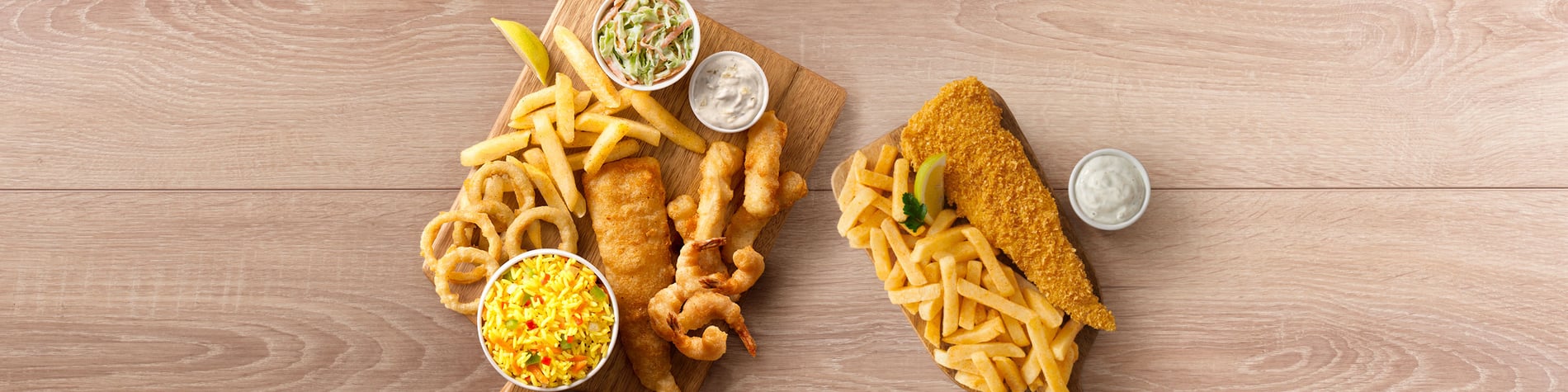 Seafood meals from Fishaways Zevenwacht Mall including a Crunchy Fish and Chips meal and a seafood Platter for One with hake, calamari, prawns, chips, onion rings, and coleslaw.