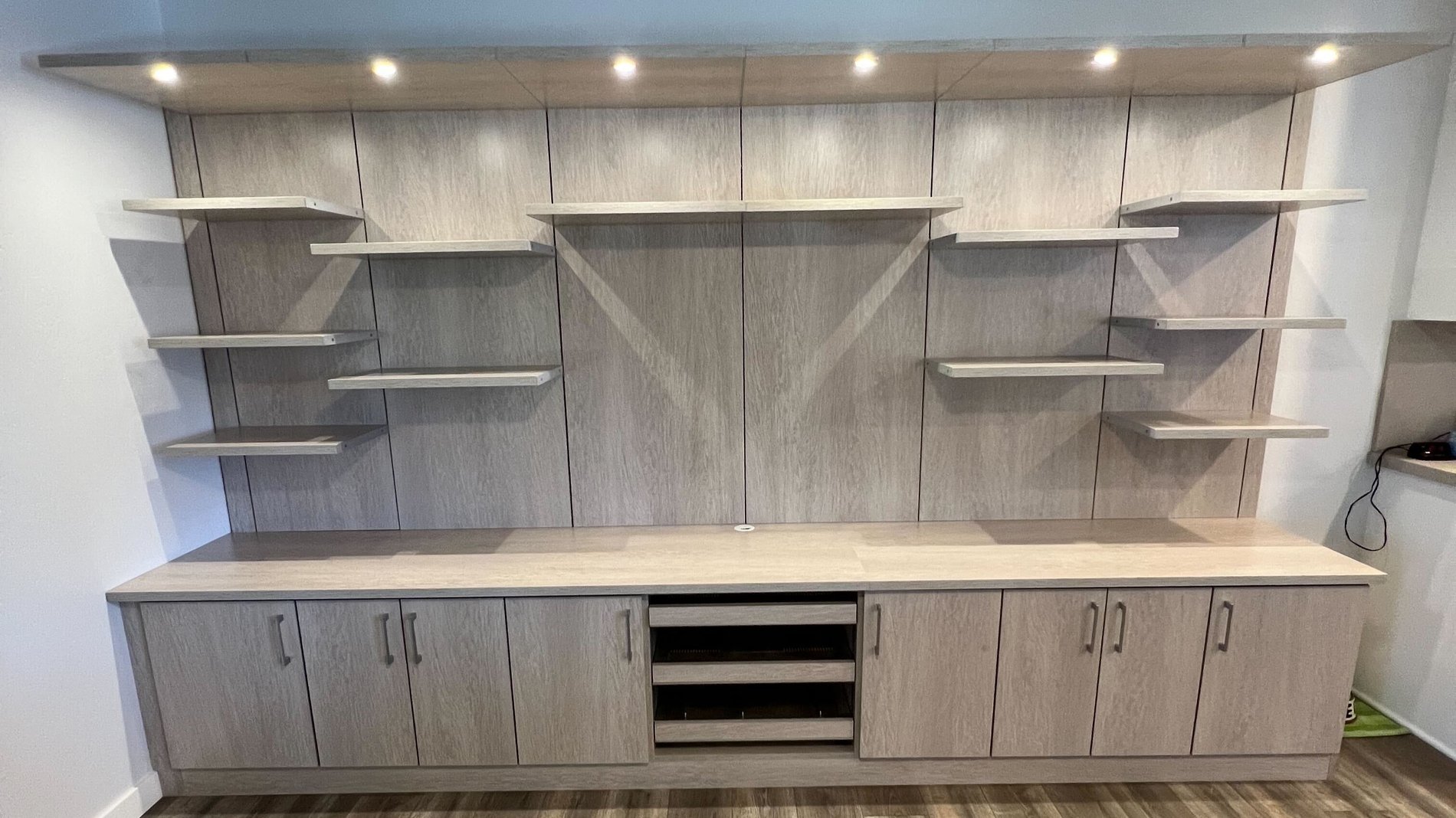 Large tan media center Custom built locally made media center in neutral tone by California Closets San Diego, California.