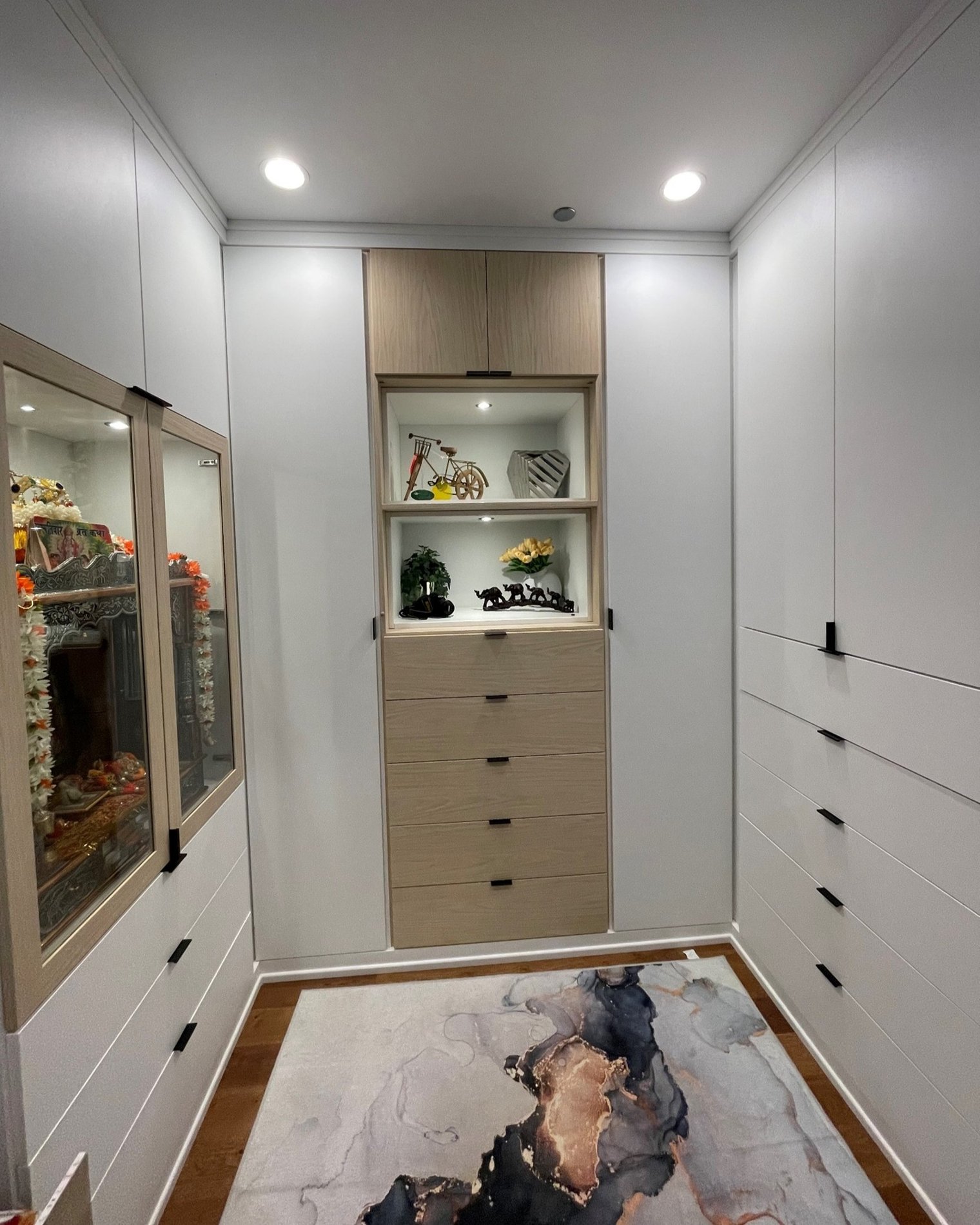 White Walk-In with Custom Lighting Luxe white walk-in closet with accenting drawer bank and lighting