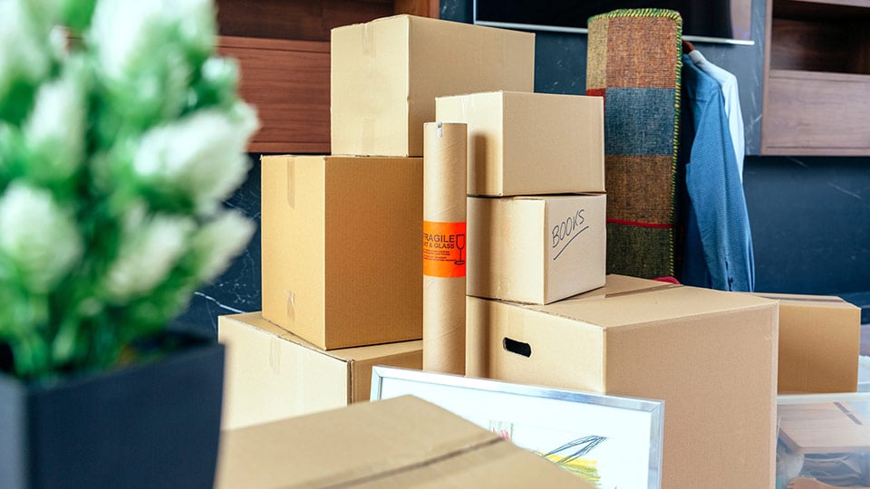 A student's entire dorm room is packed up in moving boxes