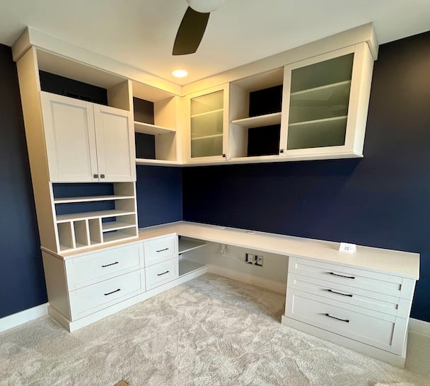 Sleek Home Office Desk Custom home office with built-in cabinets, shelving units, and storage solutions with desk workspace by California Closets Greater Detroit