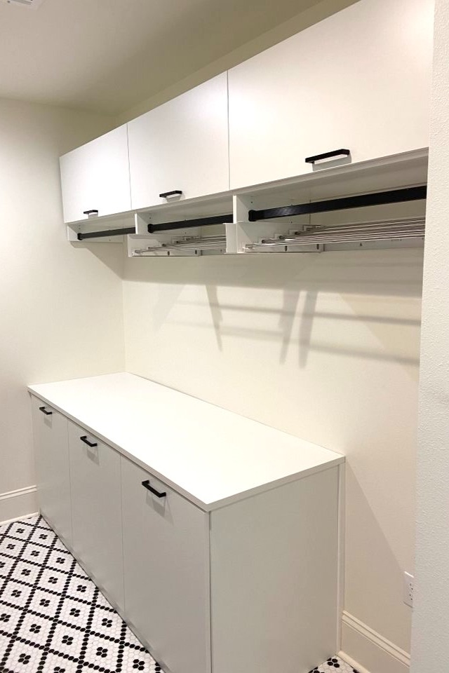 White Laundry Room Closet systems with custom cabinets for laundry rooms with laundry hamper  California Closets New Orleans & Gulf Coast