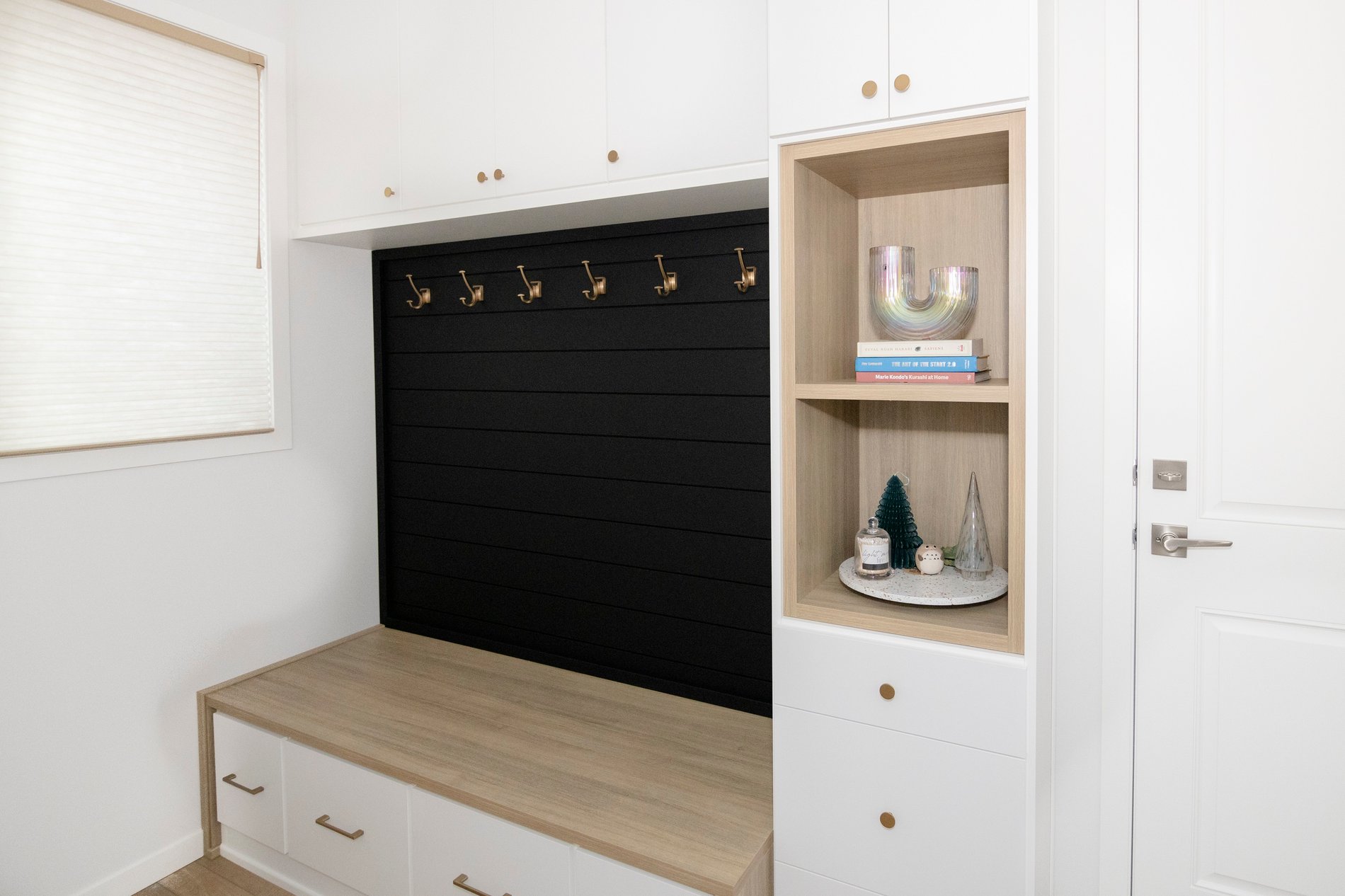 Simple Mudroom Custom mudroom design with black shiplap, wood grain bench and shelves, and white drawer fronts. Add gold hardware for a pop.