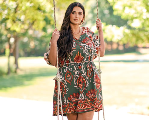 Woman is wearing a plus size short floral dress.