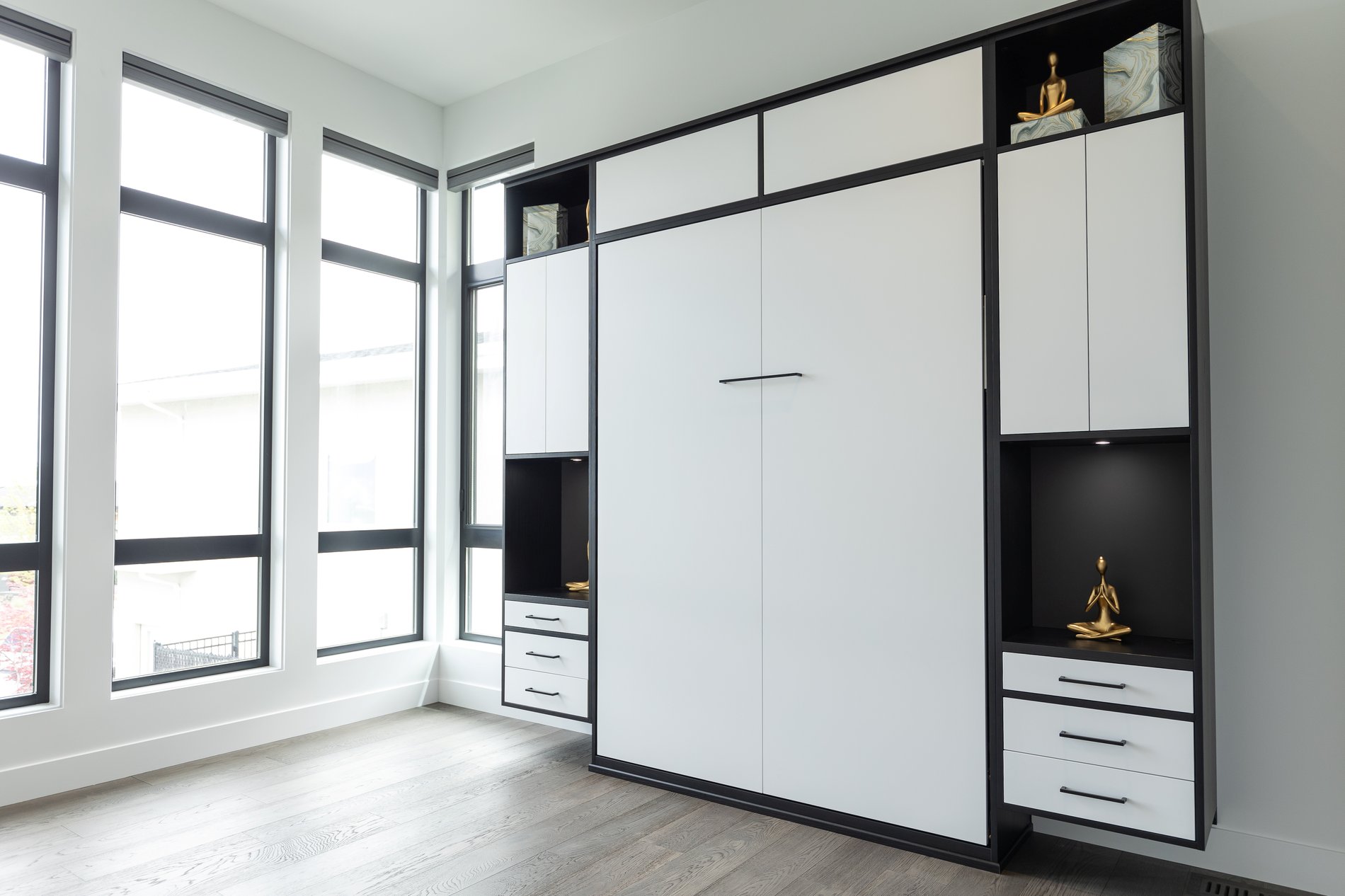 Black and white contrasty murphy bed with tons of storage Black and white murphy bed with drawers on either side and above