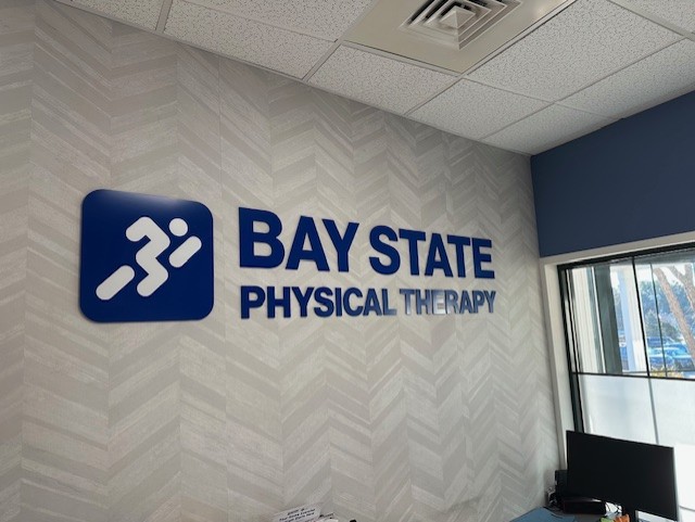 Bay State Physical Therapy Blue Logo on wall in Kingston MA Clinic.