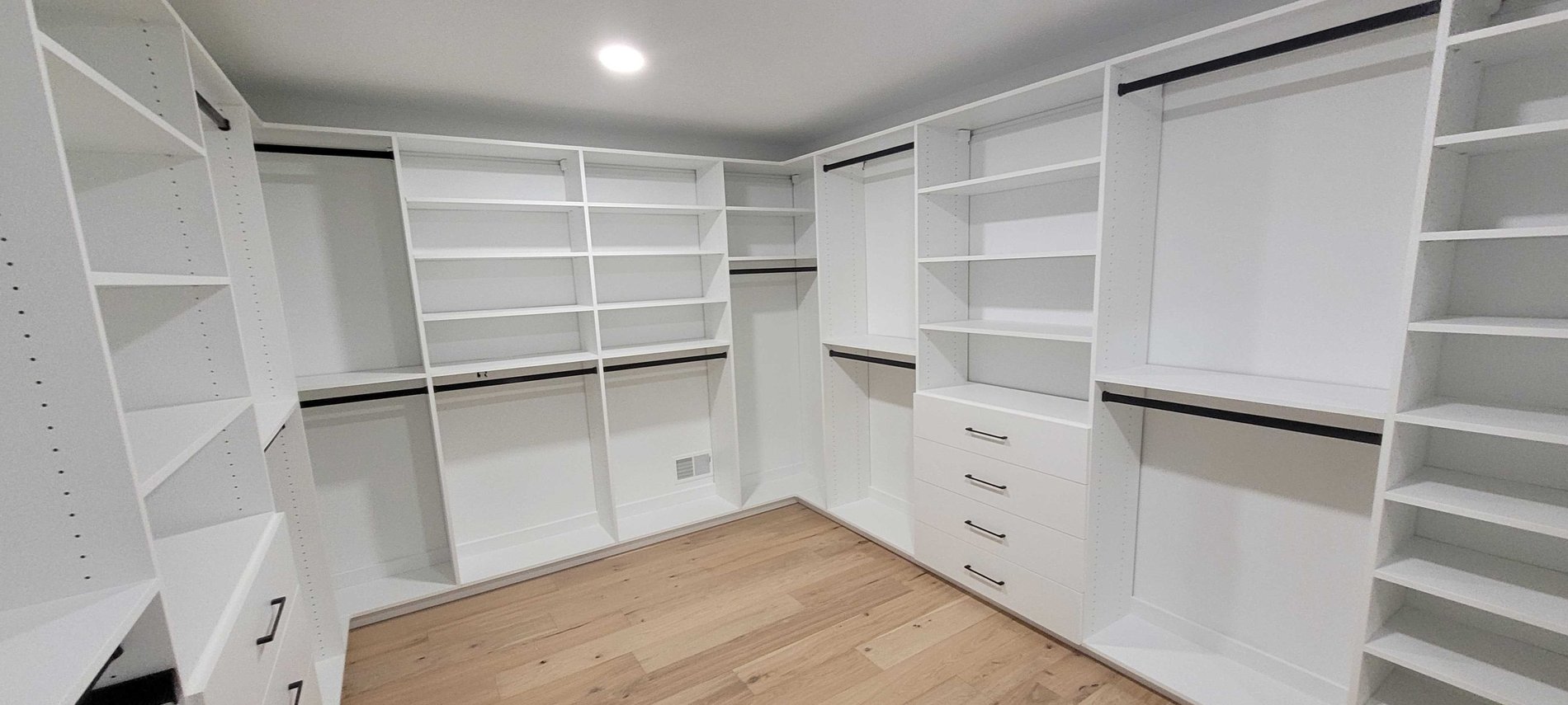 Walk in Closet White walk in closet with drawers, shelves and hanging space