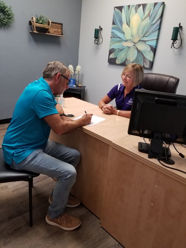 Jeannie helping a customer get his life insurance policy started.