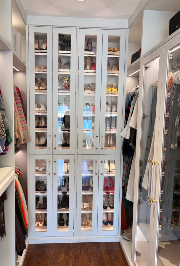 Elegant NYC Walk-in Closet Img 3 - walk in closet storage in NYC California Closet custom built closet with shaker doors and glass inserts, elegant crystal hardware and LED lighting
