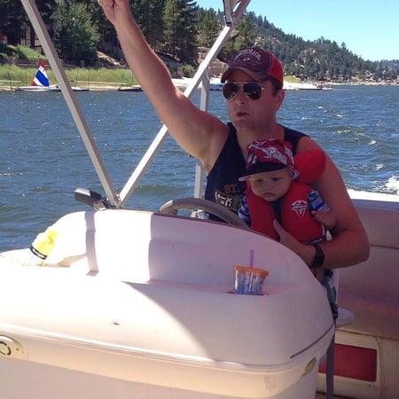 My son-in-law Nick and grandson Rocky captaining a pontoon boat at Big Bear Lake.