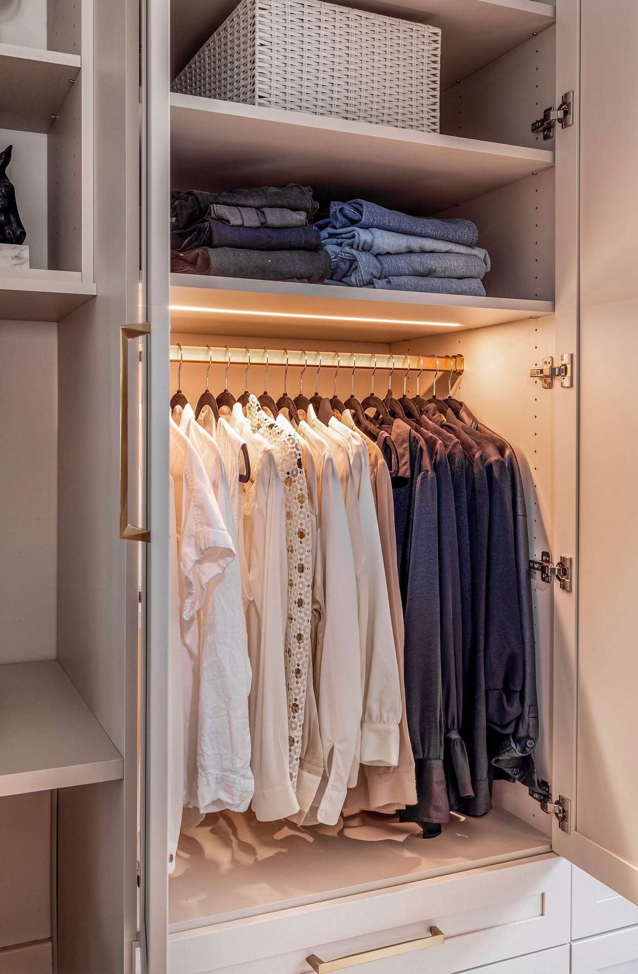 Closet System with Custom Lighting | California Closets Memphis Custom closet with drawers, shelving, and hanging space by California Closets Memphis, Tennessee.