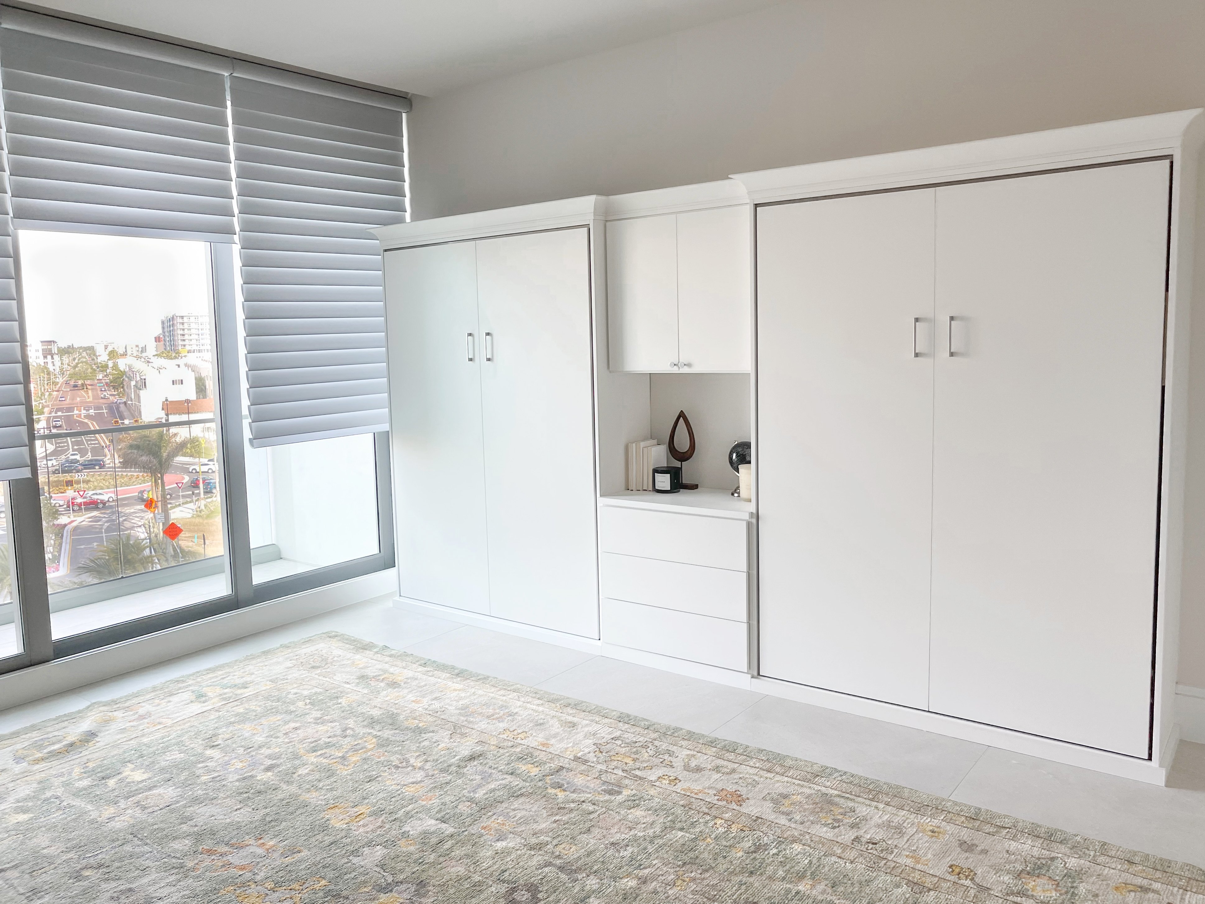 Secondary bedroom with wall beds Sleek wall beds in high rise condo by California Closets Tampa Bay, Florida.