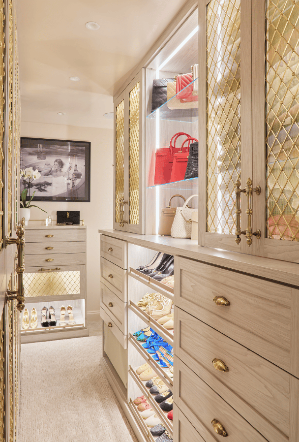 Luxe Walk-in Closet Luxe walk-in closet with gold mesh door inserts and lighting