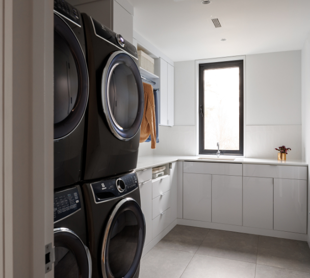 Classic White Laundry Room White laundry room custom designed for efficiency by California Closets Nassau County, New York