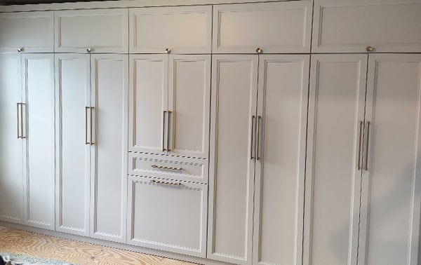 Wall of Custom Closets | California Closets Southern New Jersey Custom closet along a wall in white wood finish and metal hardware created by California Closets Southern New Jersey