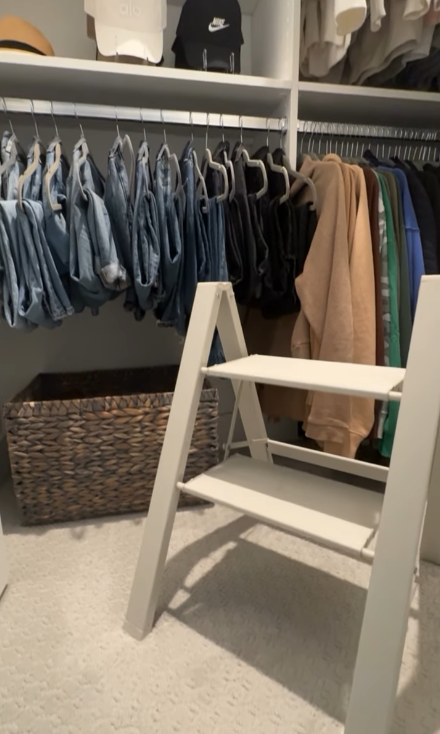Modern closet design with a step ladder for easy access by California Closets Virginia Beach, Virginia.