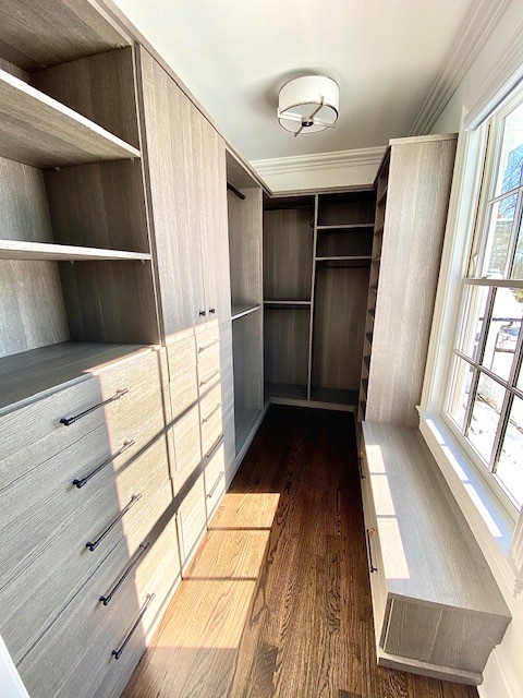 Dreamy Walk-in Closet gray walk-in closet with window bench double hanging open and closed storage drawers california closets new york