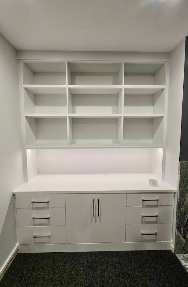 Custom Wall Unit Built-in bookshelf with cabinets and custom wall unit design featuring open shelving, concealed storage, and integrated drawers. This custom cabinetry solution provides living room storage and versatile storage solutions for a beautifully organized space. Ann Arbor, Michigan