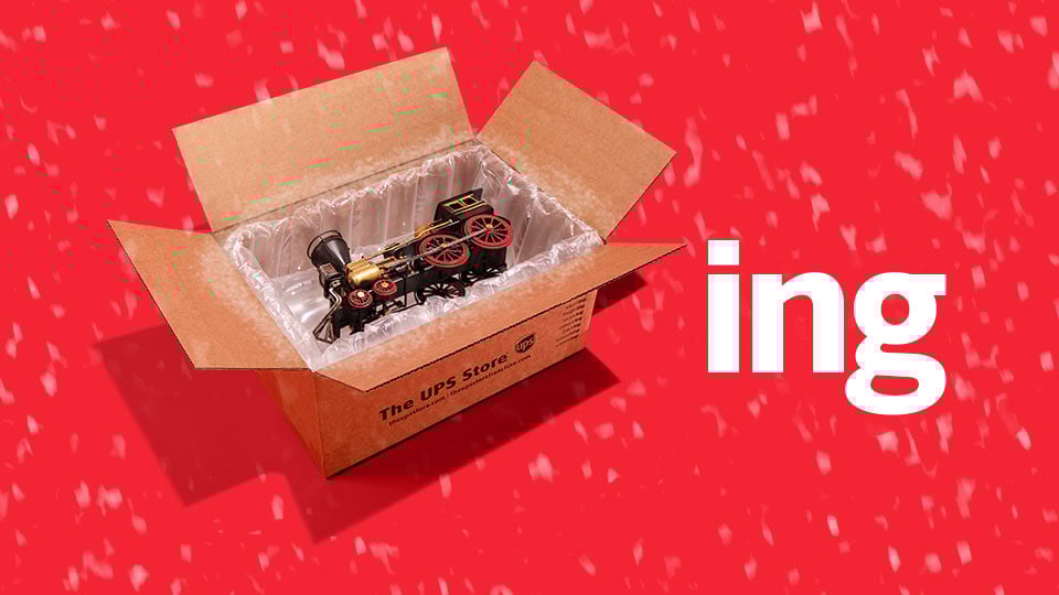 The UPS Store box packaged with a toy train next to the letters ING
