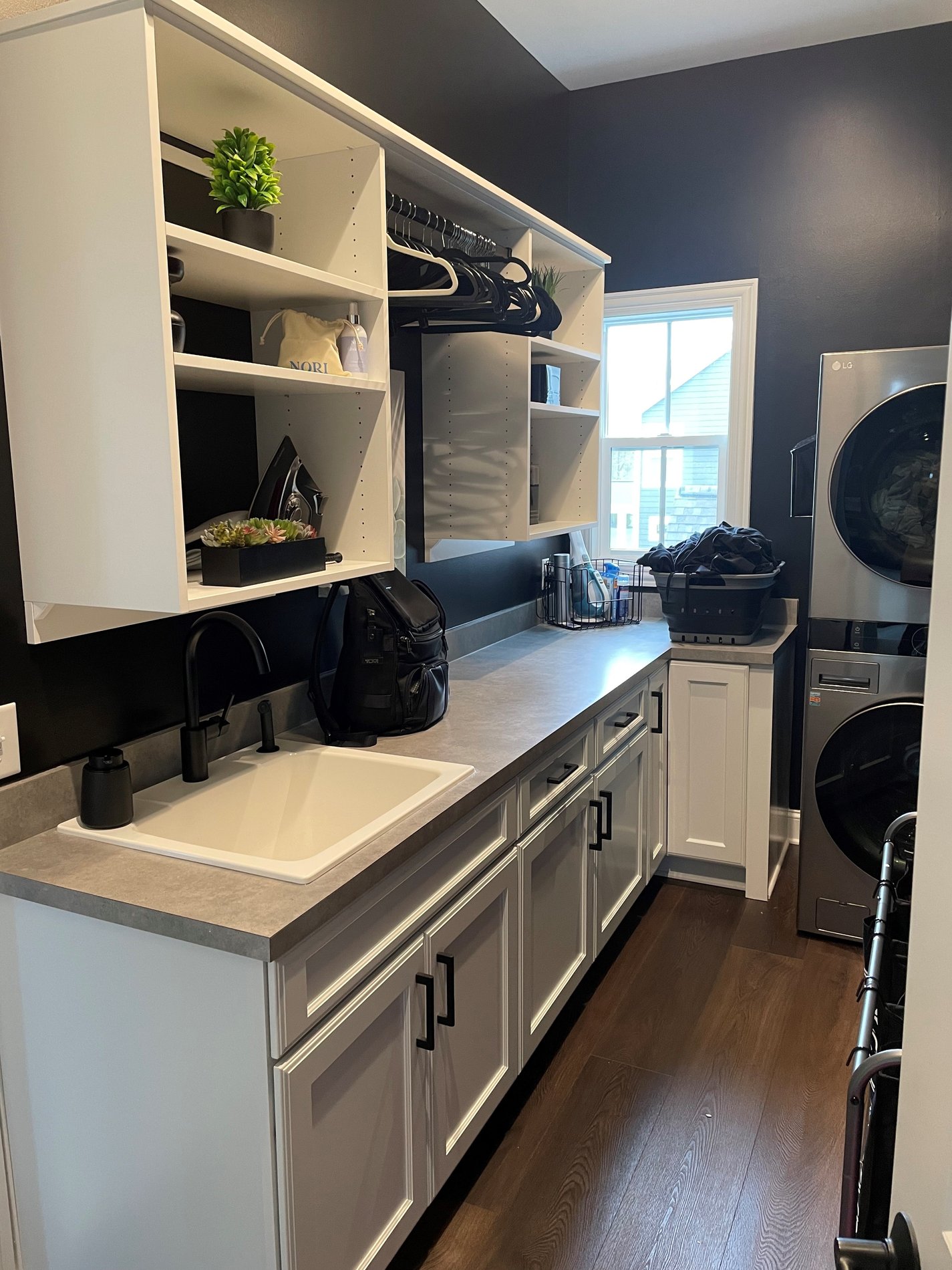 Custom Laundry Room Custom laundry room featuring shelving and cabinets for increased storage and closet organization by California Closets Columbus, Ohio.