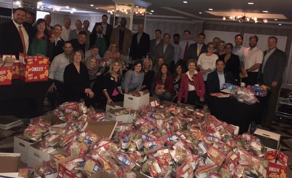 Weekend Food for Kids Program volunteers take photo with donated food