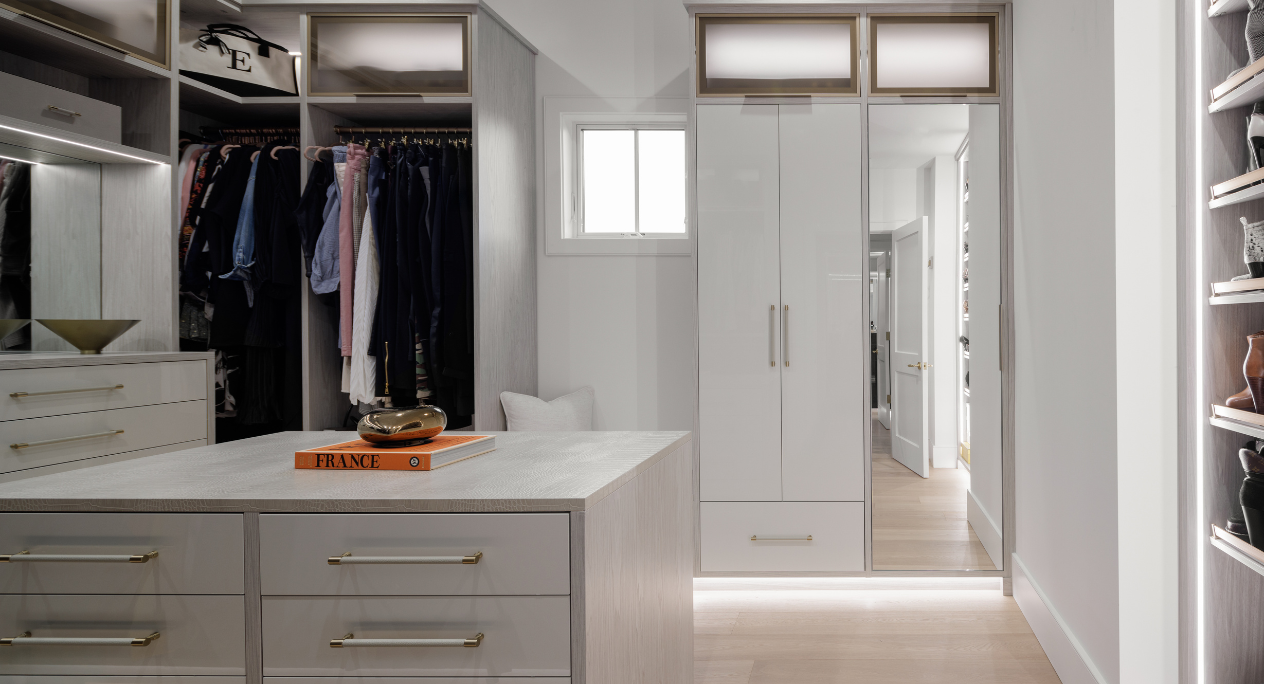 Glamourous White Walk-in Closet California Closets Rockland County NY Custom White and  Gray Walk in Closet Luxury Modern Walk in Closet High Gloss White drawers Vanity with Mirror LED Lighting custom shelving custom center island