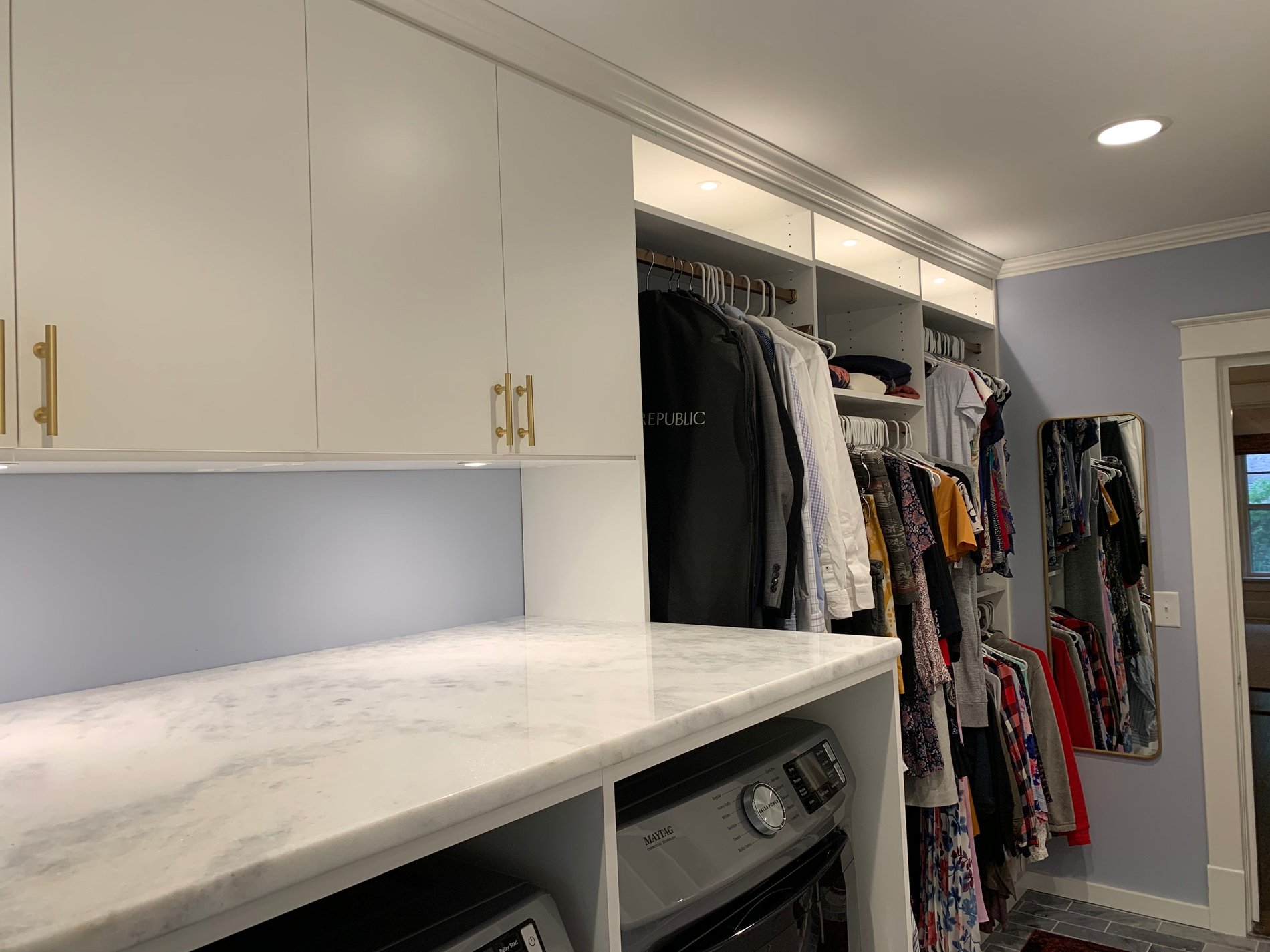 Laundry Room with Hanging Space White laundry room with hanging space and storage