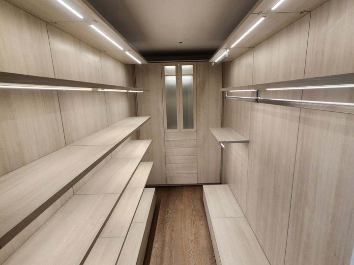 Floating Walk-In Closet Design Stunning walk-in closet system with accent lighting, floating shelves, and Virtuoso hanging poles.