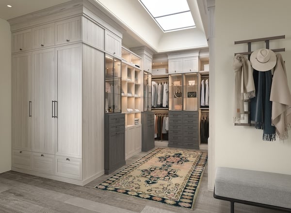 Walk-in closet with custom closet organization, floor-to-ceiling cabinetry, built-in drawers, open shelving and integrated lighting.