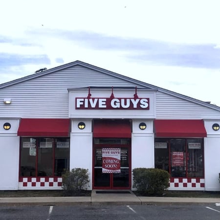 Exterior photograph of the Five Guys restaurant at 560 Washington Street in Middletown, Connecticut.