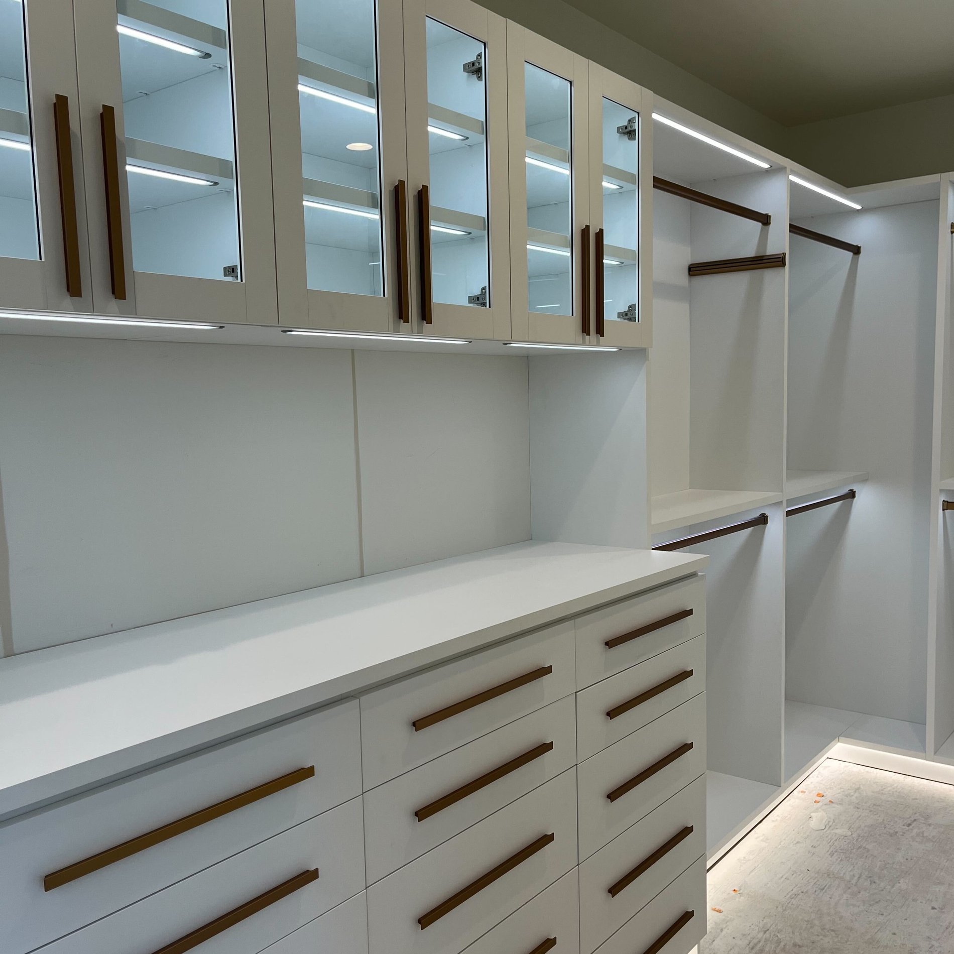 Master Walk-In Closet White walk in closet with gold accents by California Closets San Diego, California.