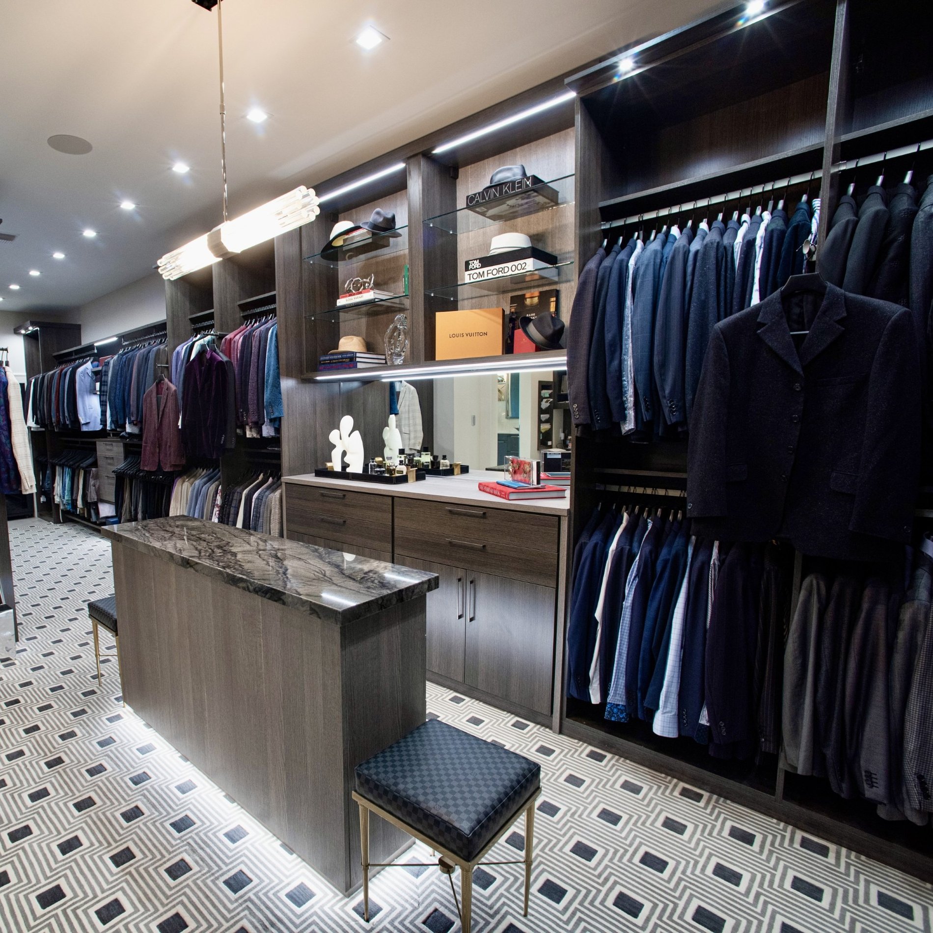 Business Men's Closet Dark brown men's closet organization with lighting and island California Closets New Orleans & Gulf Coast Louisiana.