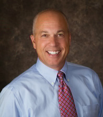 Male agent Phillip Matthews profile photo in front of a brown background