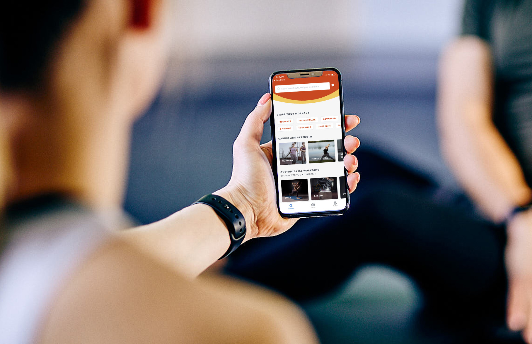 Person holding phone showing the Blink app on the screen.