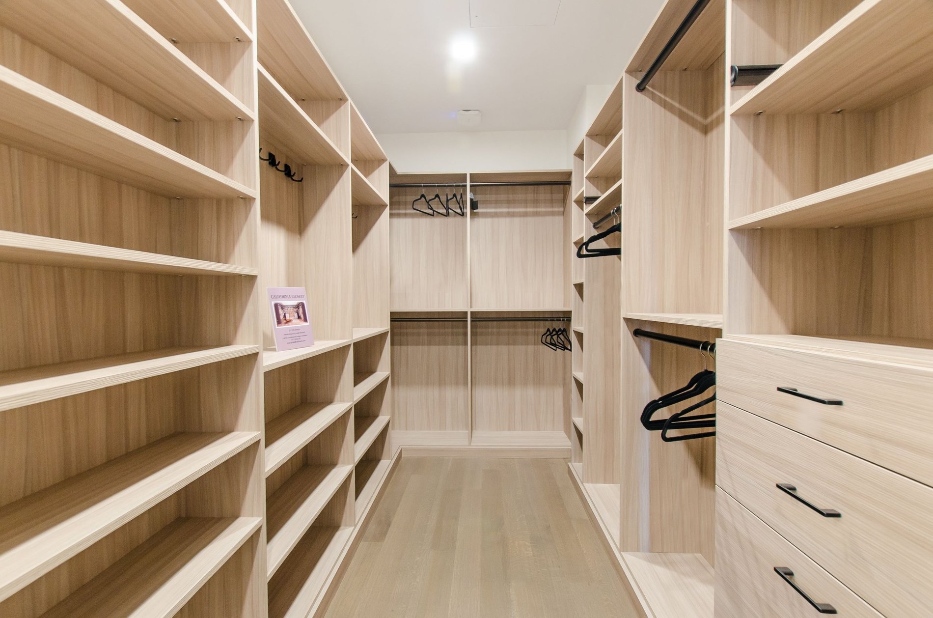Large Walk-In Closet brown walk-in closet drawers hanging black hardware
