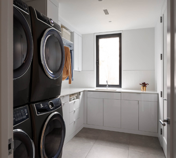 Crisp White Laundry Room Img 6 California Closets Westchester County New York Custom White Laundry Room with Closed Cabinetry for Laundry supplies and space for a double washer and dryer