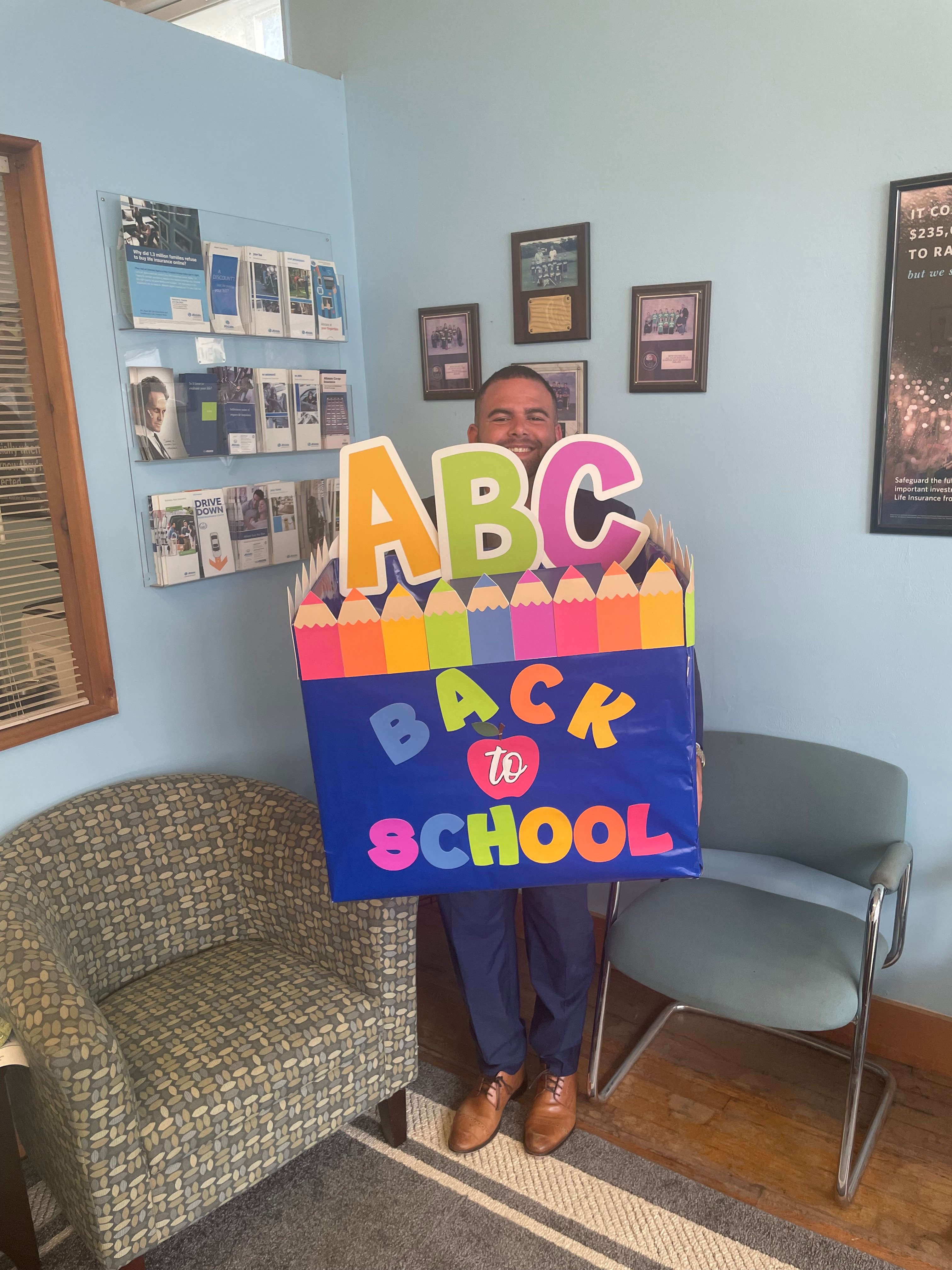 Our exclusive agent, Brian Pellone, getting weighed down and excited to bring down the box full of school supplies to our local Hampton Bays Elementary school.