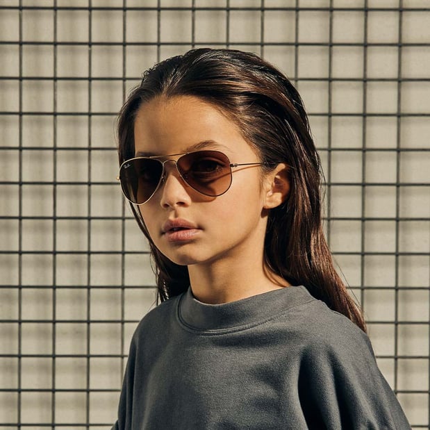 Young girl wearing Ray-Ban sunglasses