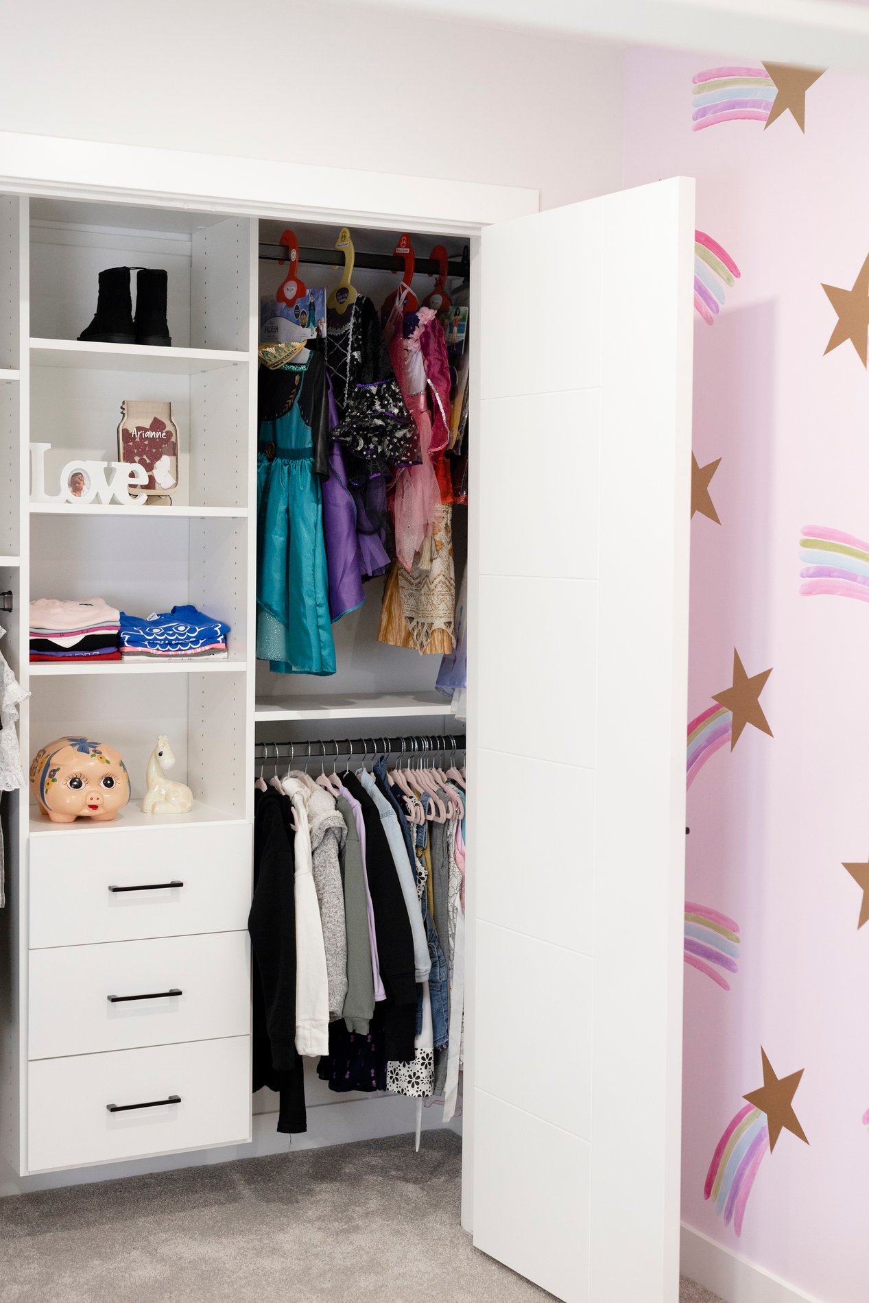 Sweet Girls Reach In Closet Girls closet with double hang, open shelves, and drawers.