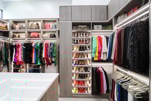 Walk-in closet with cabinets, shelves, drawers, and shoe storage by California Closets St. Petersburg, Florida.