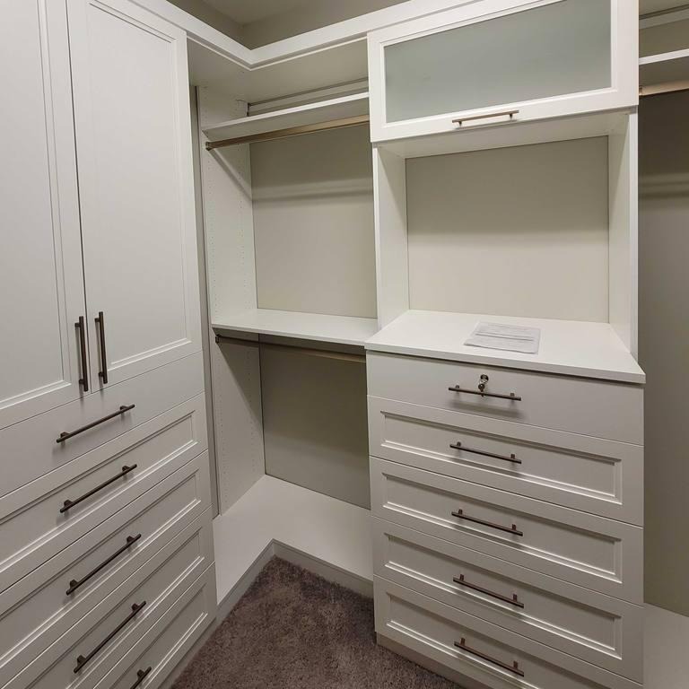 Sleek White Closet for Everyday Ease A white walk-in closet designed for organized storage.