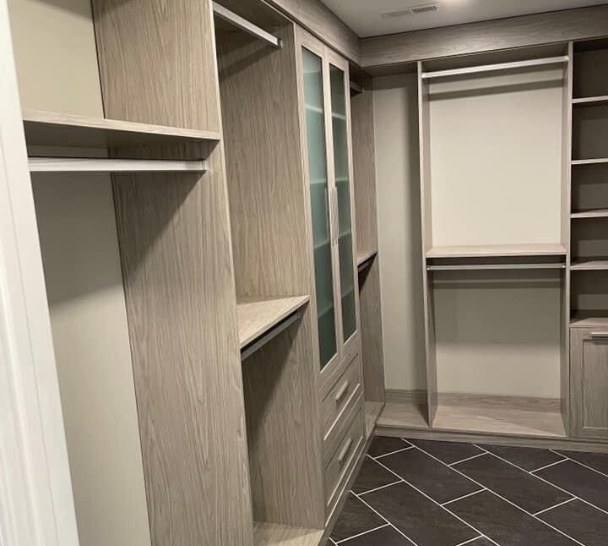 Custom Walk-In Closet Walk-in closet with custom shelving, drawers, and hanging spaces.