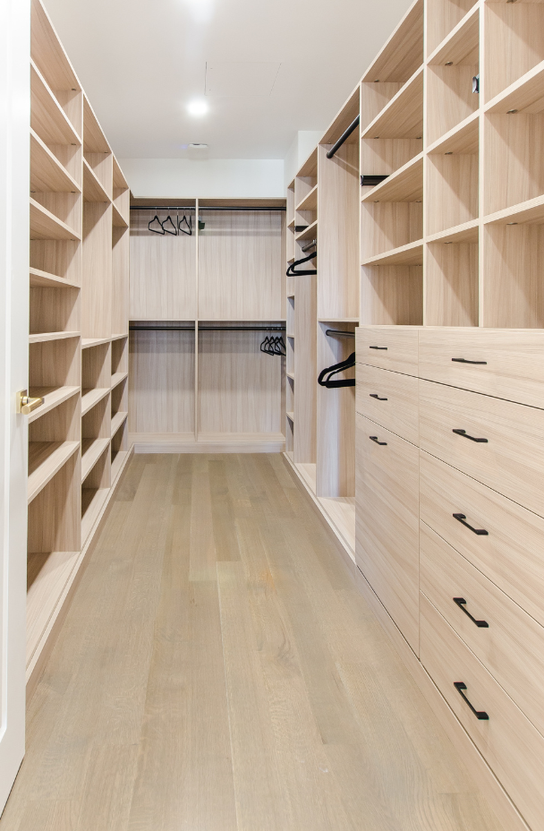 Women's Walk-in Closet California Closets New York NY Walk-in Closet with Various Storage Options with Drawers, Cubby-like Shelving, Double Hanging and Black Hardware