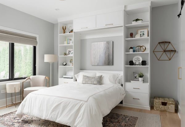 Murphy bed with drawers, shelves, and cabinets in white finish by California Closets Buffalo and Rochester, New York.