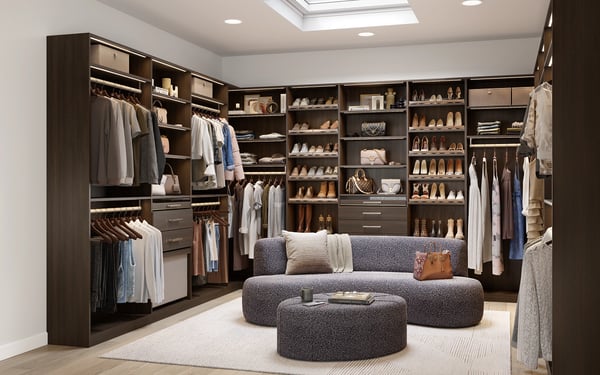 Walk-in closet with custom cabinets, shelves, and drawers by California Closets Buffalo and Rochester, New York.