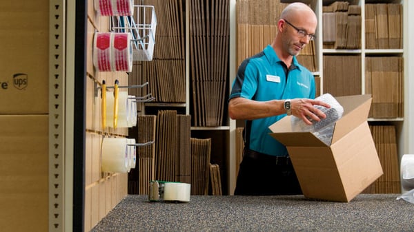 The UPS Store Franchisee packing a box